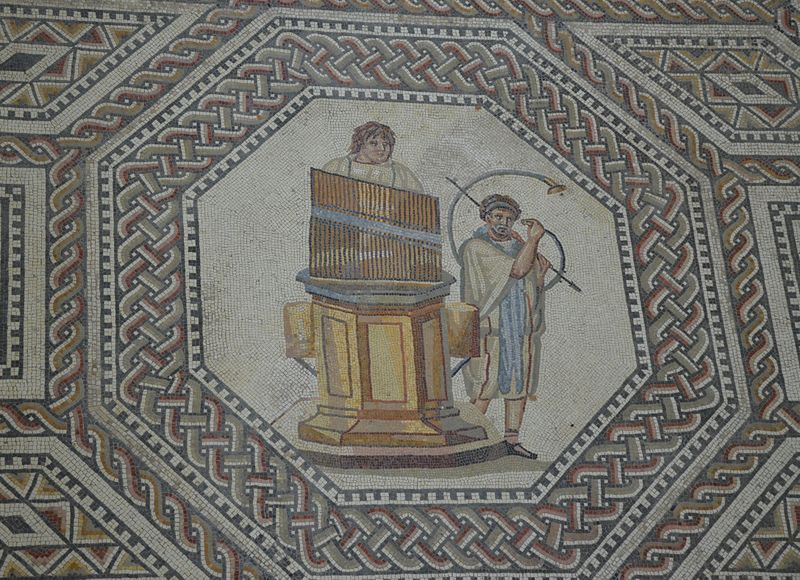 File:Organist and horn player, the gladiator mosaic at the Roman villa in Nennig, Germany (9291661708).jpg